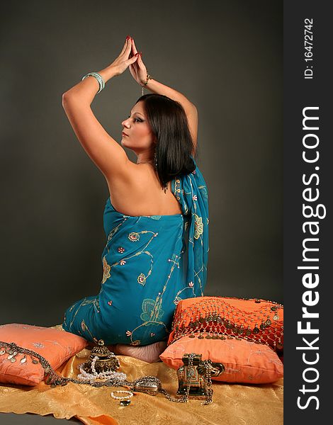 Beautiful indian woman laying in ethnic interior. Beautiful indian woman laying in ethnic interior