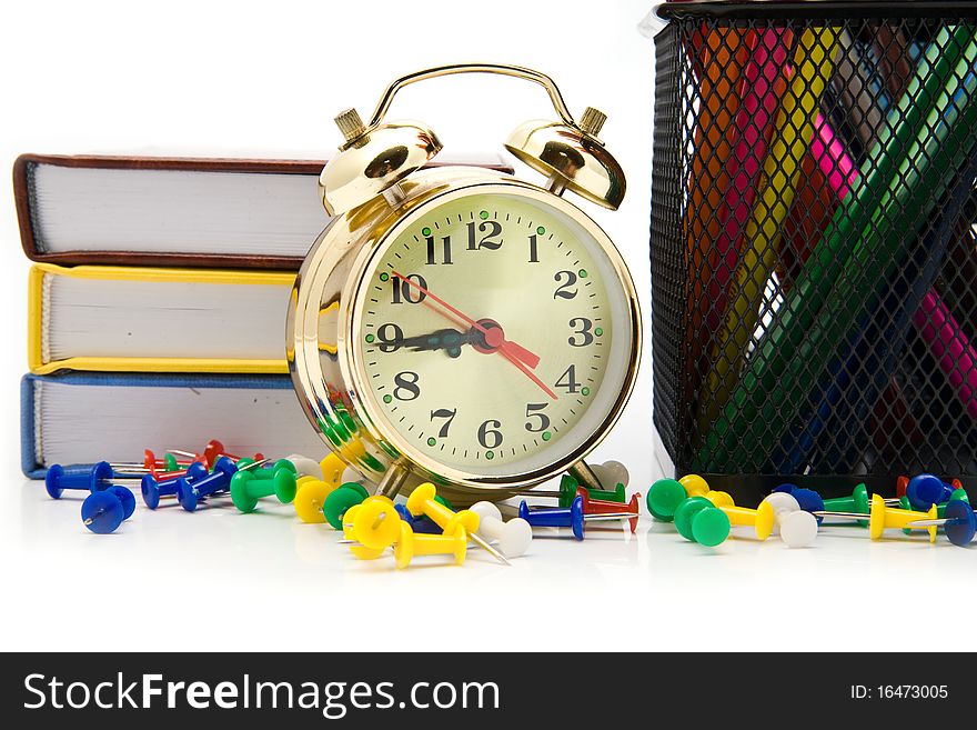 Books, clock and pencils on a white background