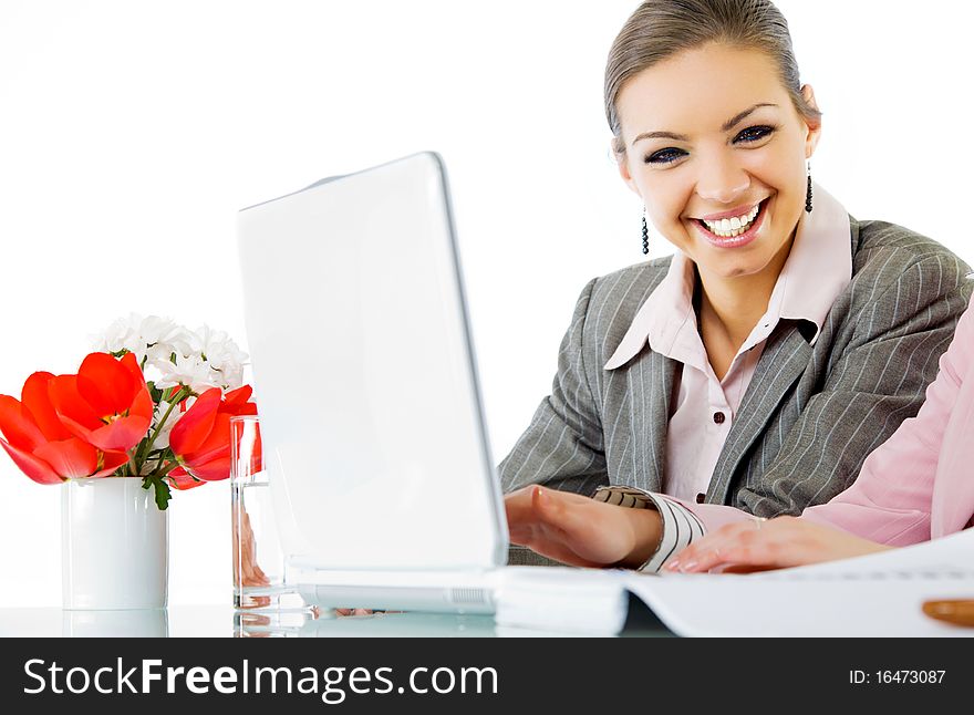 Happy businesswoman sitting behind laptop smiling, colegue partialy seen. Happy businesswoman sitting behind laptop smiling, colegue partialy seen
