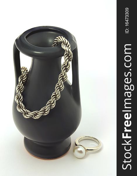 Dark souvenir vase, silver chain and silver ring with a pearl. Dark souvenir vase, silver chain and silver ring with a pearl.
