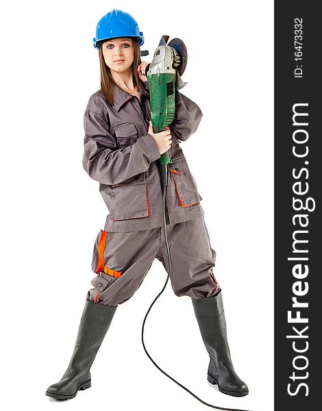 Beautiful young female with workwear and boots standing and holding grinder. Beautiful young female with workwear and boots standing and holding grinder