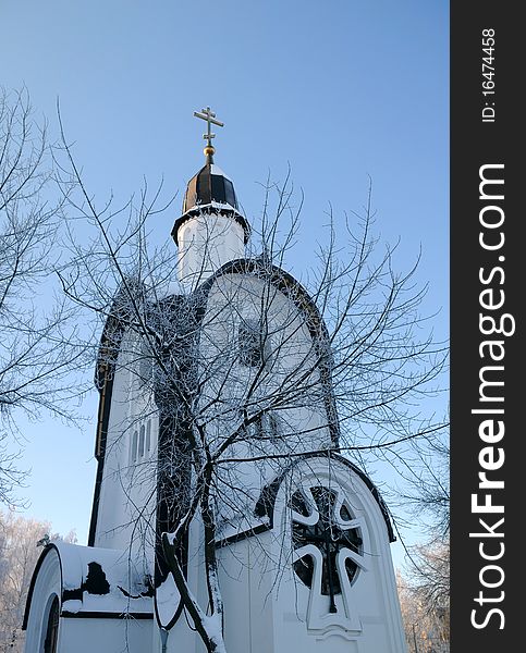 Portion of little white chapel in the background of the blue sky in the town of Korolev near Moscow in Russia. Portion of little white chapel in the background of the blue sky in the town of Korolev near Moscow in Russia