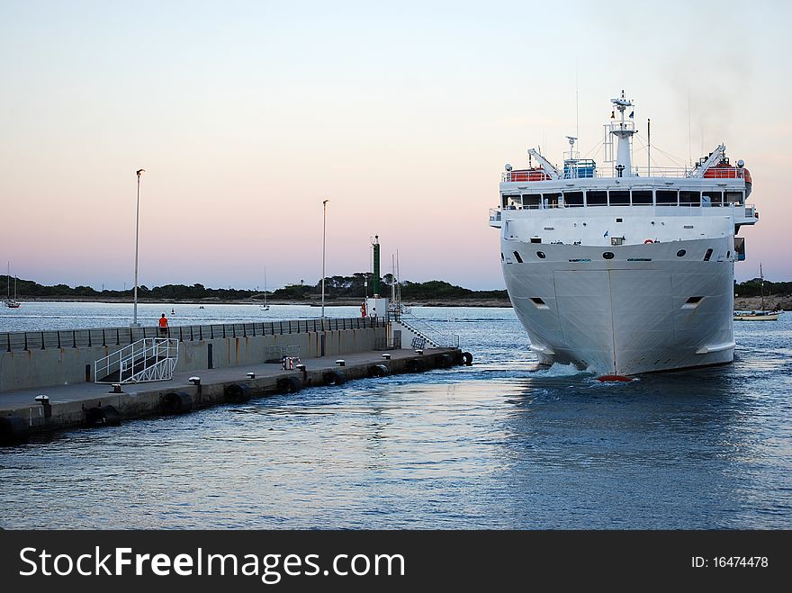 Ship maneuvering to moor at the port of Formentera. Ship maneuvering to moor at the port of Formentera.