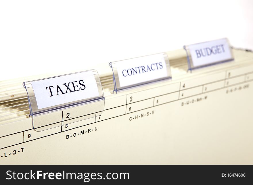 Hanging files with tabs labeled with the words taxs, contract and budget