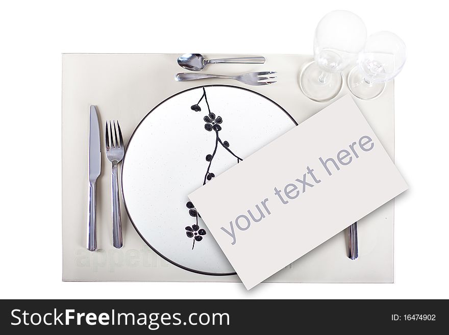 A dinner plate, knife, spoon and fork