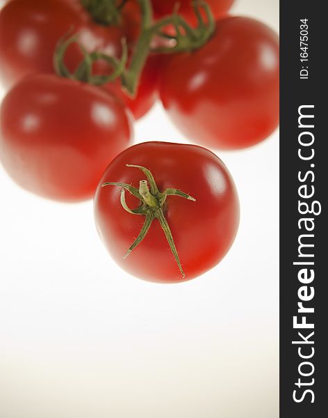 Tomatoes one in front of others red green white. Tomatoes one in front of others red green white