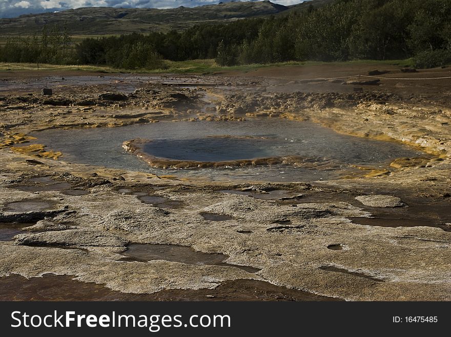 Icelands famous geyser Strokkur erupts. Nice shot at a sunny day against a cloudy sky. Icelands famous geyser Strokkur erupts. Nice shot at a sunny day against a cloudy sky.