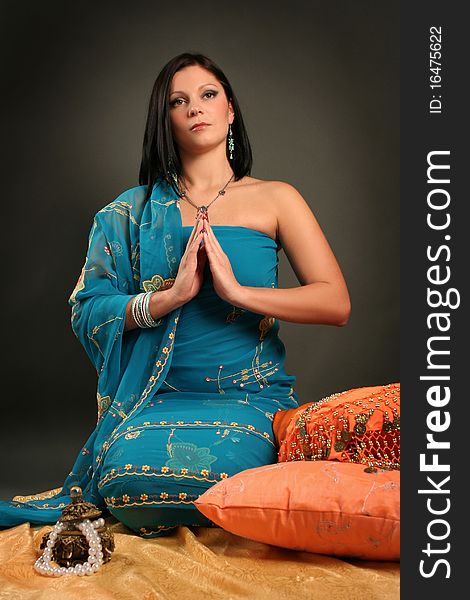 Beautiful indian woman laying in ethnic interior. Beautiful indian woman laying in ethnic interior