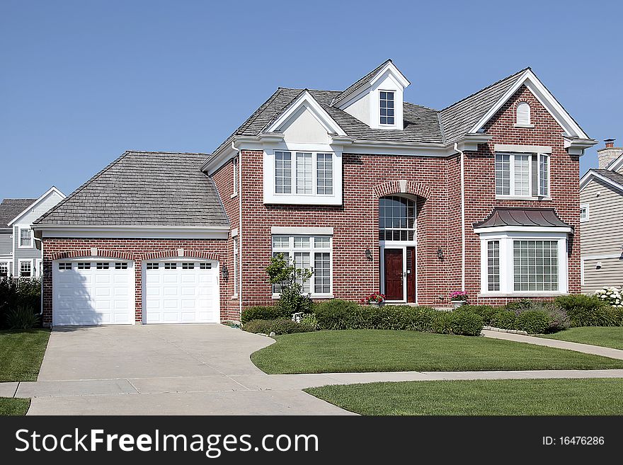 Brick home in suburbs with arched entry. Brick home in suburbs with arched entry