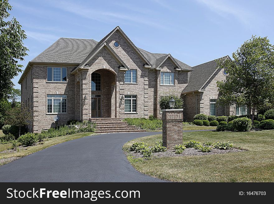 Large brick home with arched entry