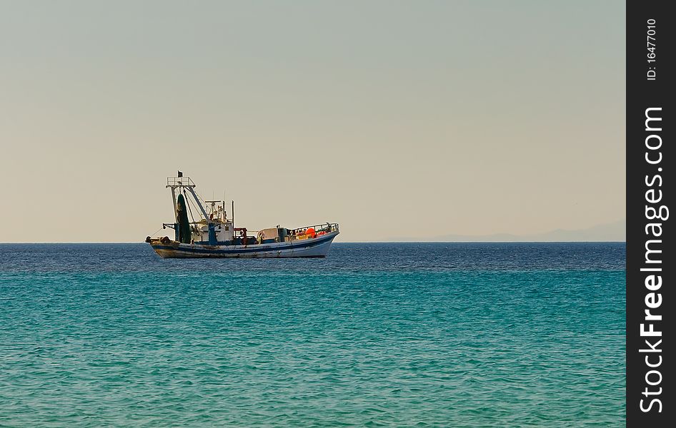 Fishing boat goes to fish in the evening