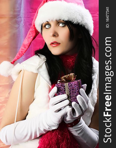 young woman with Christmas elf costume and present. young woman with Christmas elf costume and present.