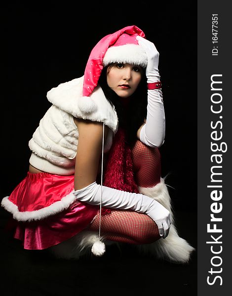 santa's helper in pink and white over dark background. santa's helper in pink and white over dark background.