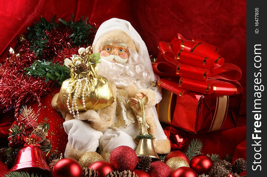 A toy Santa Claus on a background with red ribbons