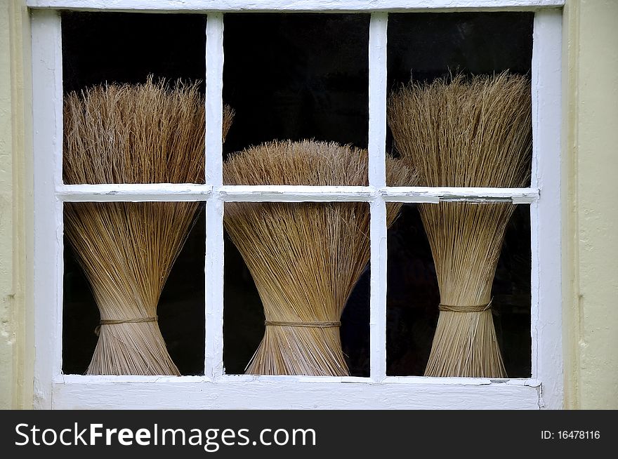 This is an image of three brooms throught a window at Shaker Village in Pleasant Hill Kentucky. It was also known as Shaker town. The Shakers were a small religious sect that began in the late 18th Century. There is a small number practicing their religion today. This is an image of three brooms throught a window at Shaker Village in Pleasant Hill Kentucky. It was also known as Shaker town. The Shakers were a small religious sect that began in the late 18th Century. There is a small number practicing their religion today.
