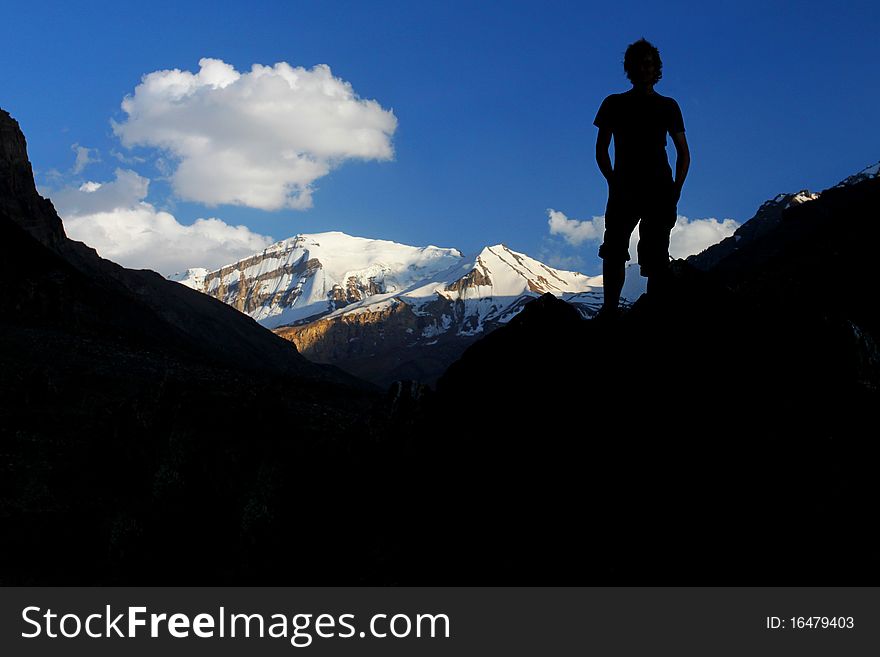 Silhouette of a climber with snow coverd peak in the background. Silhouette of a climber with snow coverd peak in the background