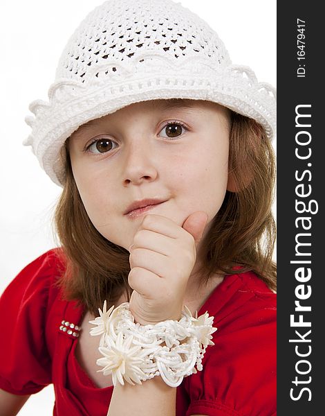 Portrait of the little girl in a white knitted cap. White background. Portrait of the little girl in a white knitted cap. White background.