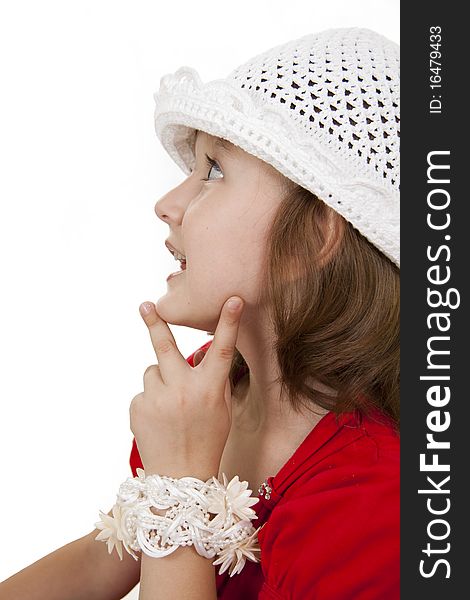 Portrait of the little girl in a white knitted cap. White background. Portrait of the little girl in a white knitted cap. White background.