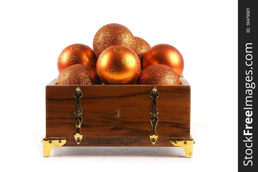 A chest full of different golden Christmals balls. The image is isolated on a white background. A chest full of different golden Christmals balls. The image is isolated on a white background.