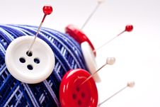 Pins In Wool Ball With Buttons Royalty Free Stock Photography