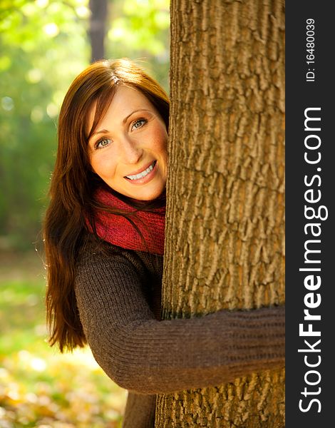 Park portrait woman with scarf embracing tree. Park portrait woman with scarf embracing tree