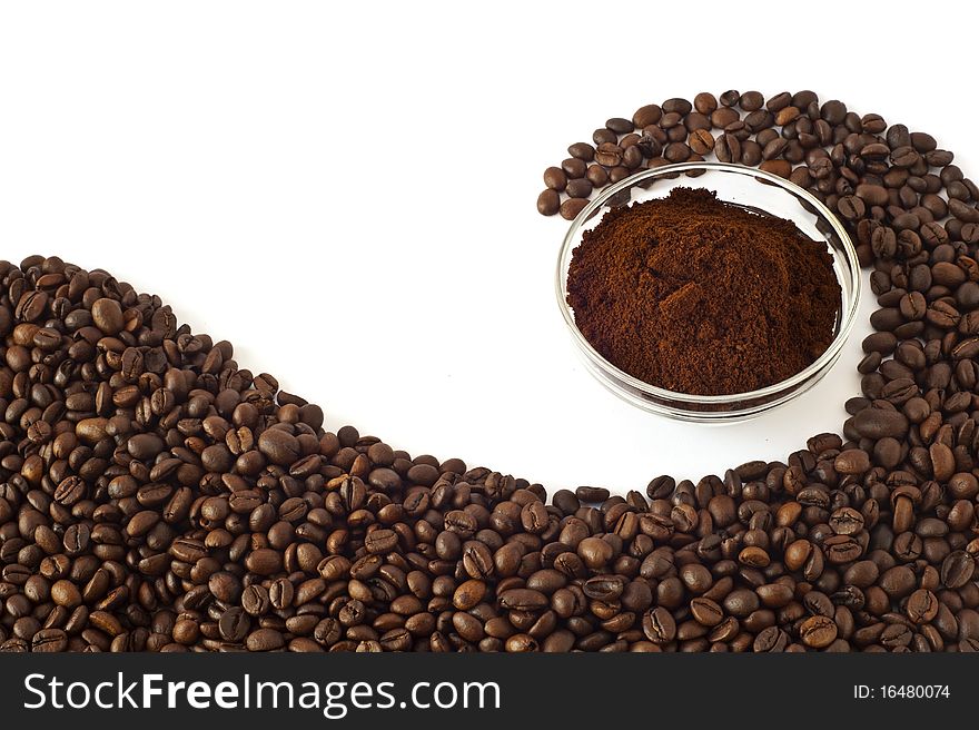 Coffee beans and ground coffee on a white background