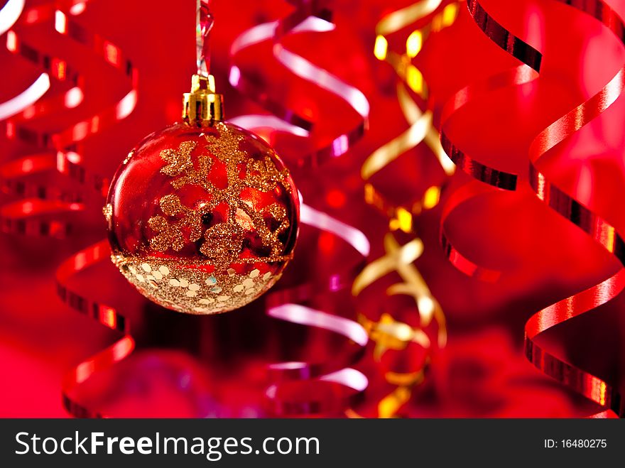 Christmas baubles and ribbons on red background. Studio shot. Christmas baubles and ribbons on red background. Studio shot