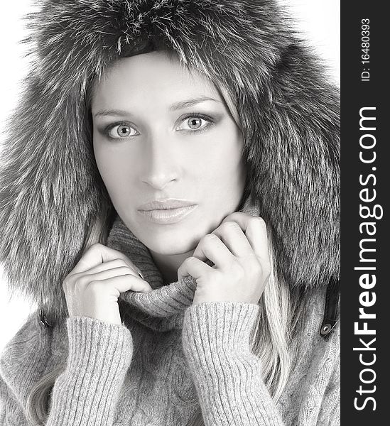 Portrait of a young and attractive woman in a winter hat. The image is isolated on a white background and slightly desaturated. Portrait of a young and attractive woman in a winter hat. The image is isolated on a white background and slightly desaturated.