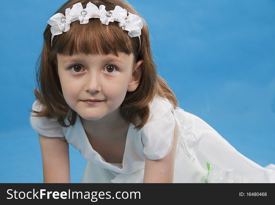 The girl the princess in a white dress. Blue background. The girl the princess in a white dress. Blue background.