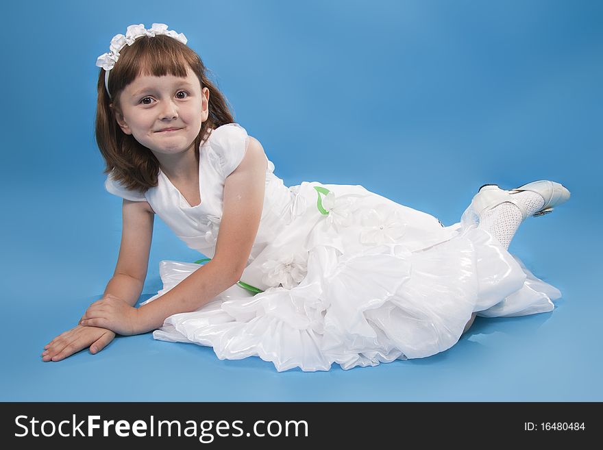 The girl the princess in a white dress. Blue background. The girl the princess in a white dress. Blue background.