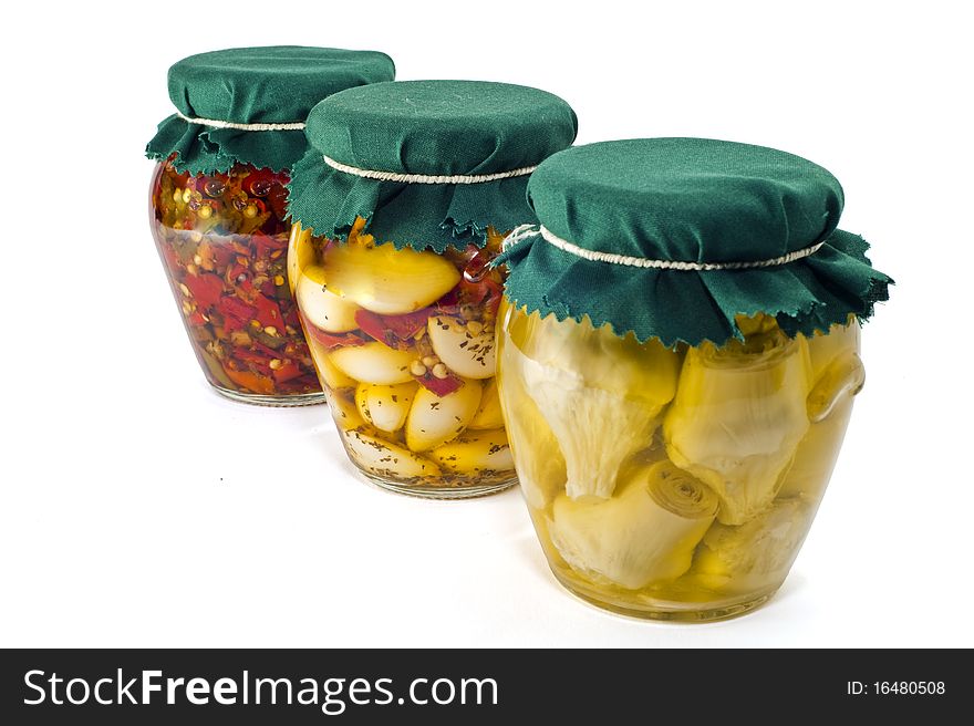 Three jars of pickled vegetables on white background. Three jars of pickled vegetables on white background