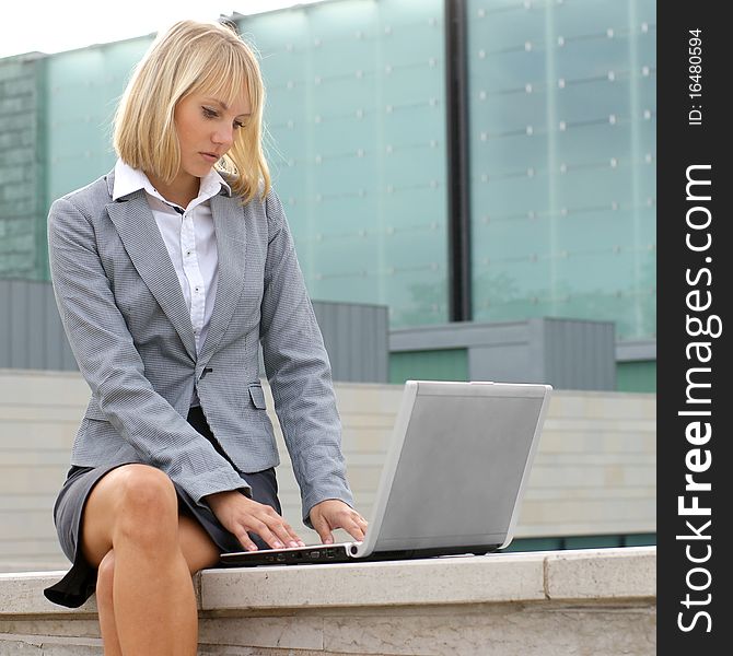 A Young Businesswoman Is Working Outdoors