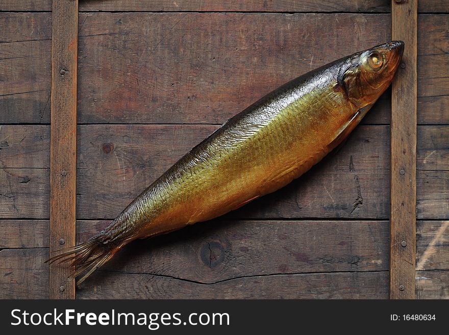 Closeup of fresh bloater lying on wooden background. Closeup of fresh bloater lying on wooden background