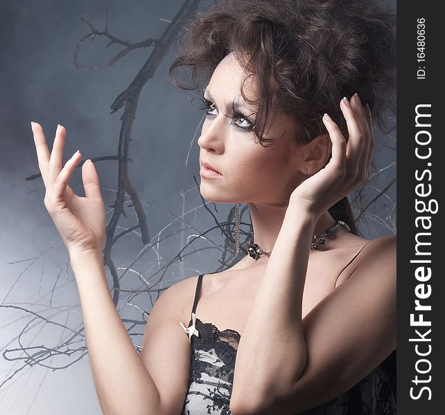 Fashion shot of a young brunette in a dark dress