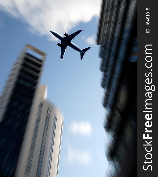 Aircraft flies over tower blocks with zoom effect. Aircraft flies over tower blocks with zoom effect