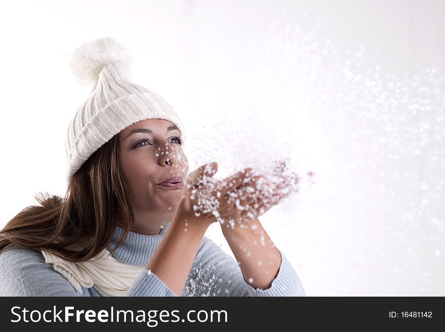 Beautiful woman blowing powder snow. Beautiful woman blowing powder snow