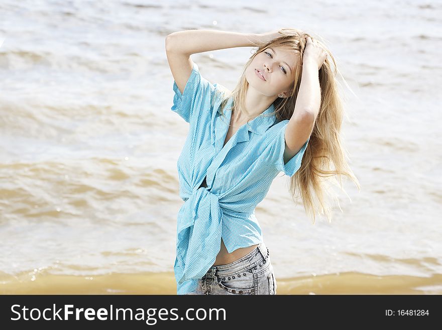 Portrait of a beautiful young woman at the sea