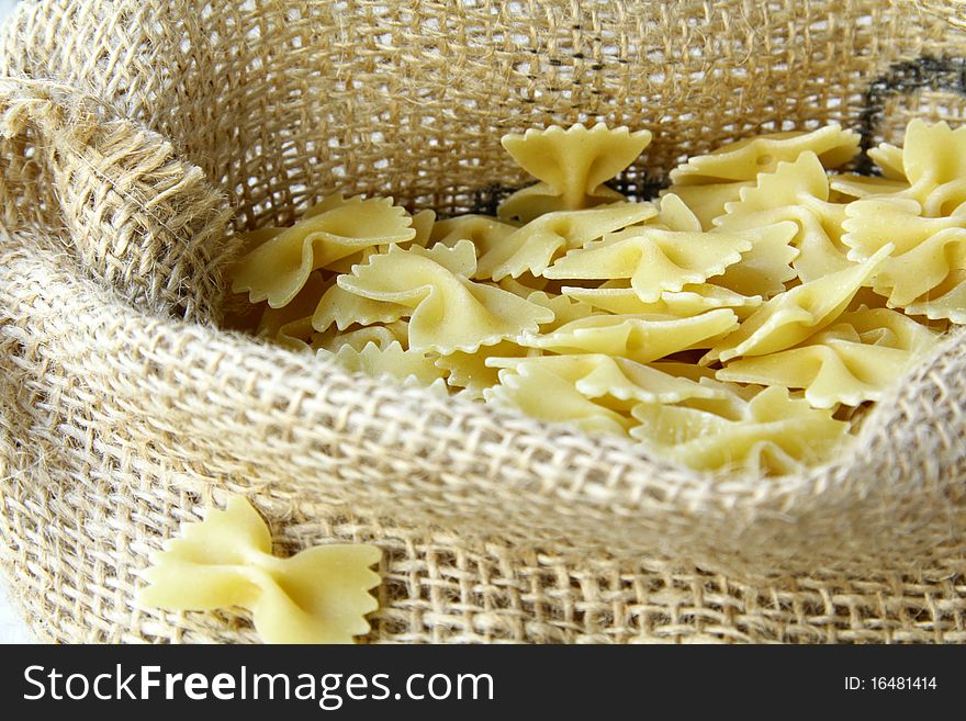 A lot of pasta in a bag on a wooden table