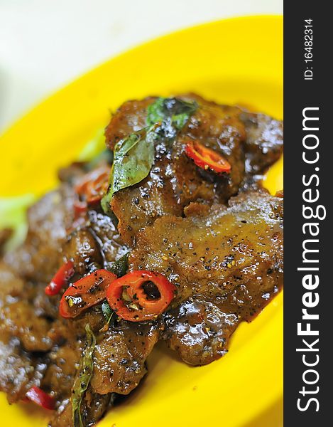 Vegetarian black pepper pork cooked using mock meat slices.