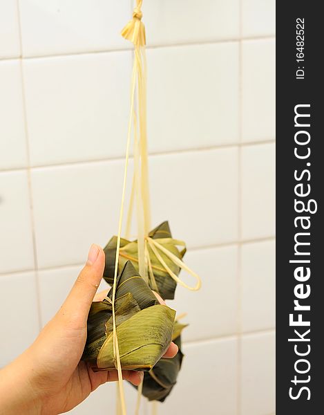 Asian glutinous dumplings wrapped in bamboo leaf. For food and beverage, culture and creative cuisine concepts. Asian glutinous dumplings wrapped in bamboo leaf. For food and beverage, culture and creative cuisine concepts.