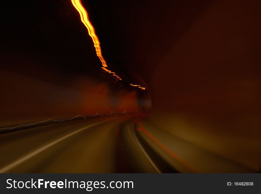 Through the tunnel at night with a car. Through the tunnel at night with a car.