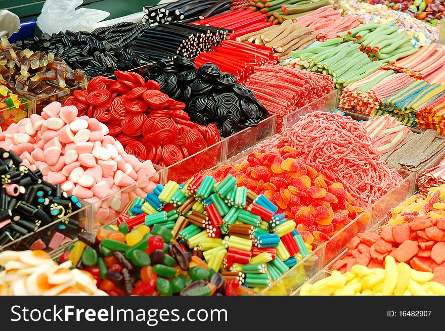 Many colorful candies on market stand
