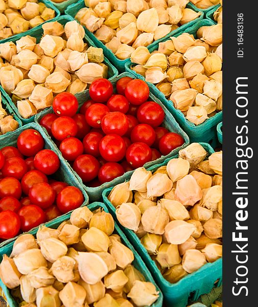 Ground cherries and cherry tomatoes for sale at a farmer's market. Ground cherries and cherry tomatoes for sale at a farmer's market