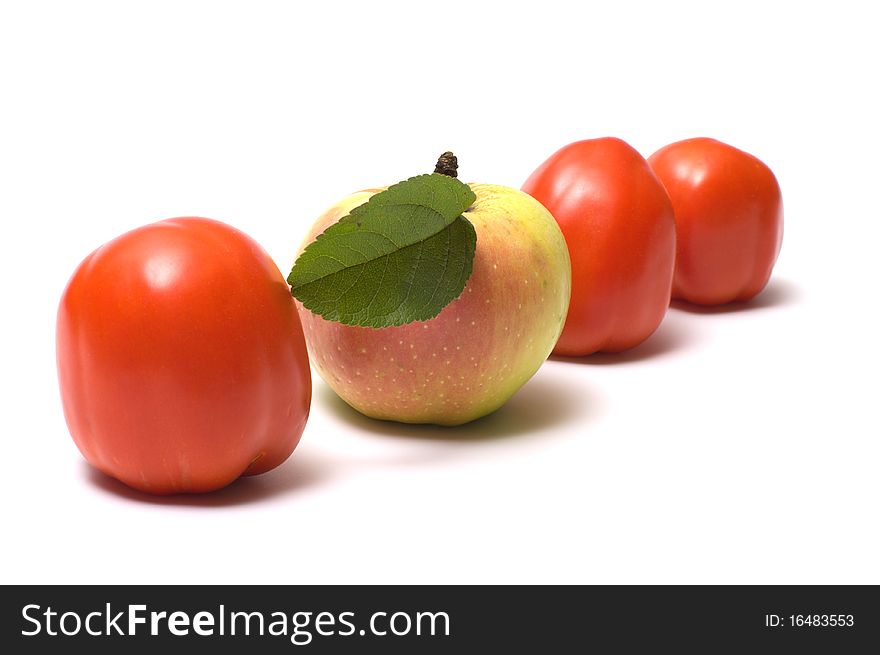 Three red tomato and apple on a white background. Three red tomato and apple on a white background.