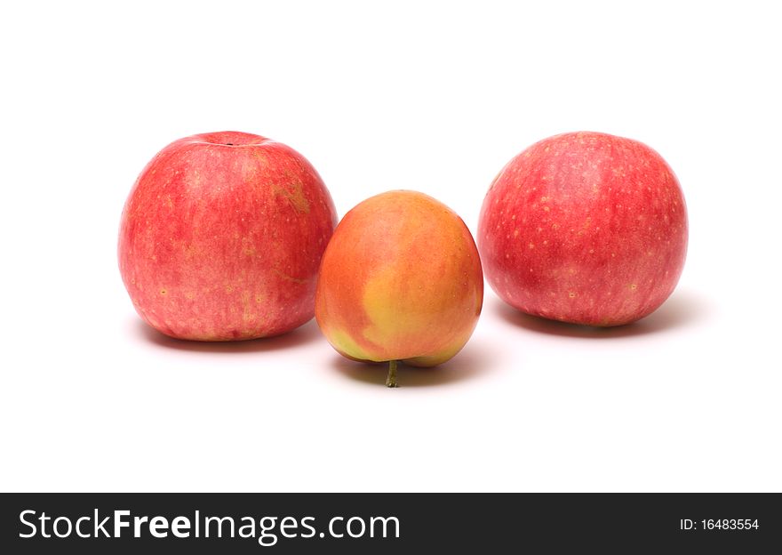 Three ripe apples isolated on a white background. Three ripe apples isolated on a white background.