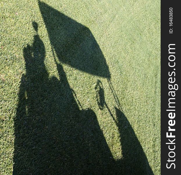 Sun creates a golf cart shadow on the fairway