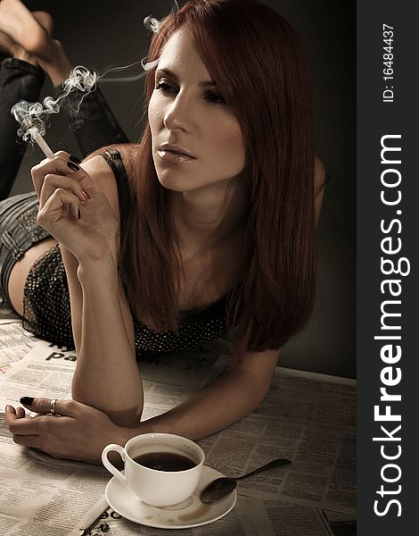 Beautiful young woman smoking cigarette. Beautiful young woman smoking cigarette