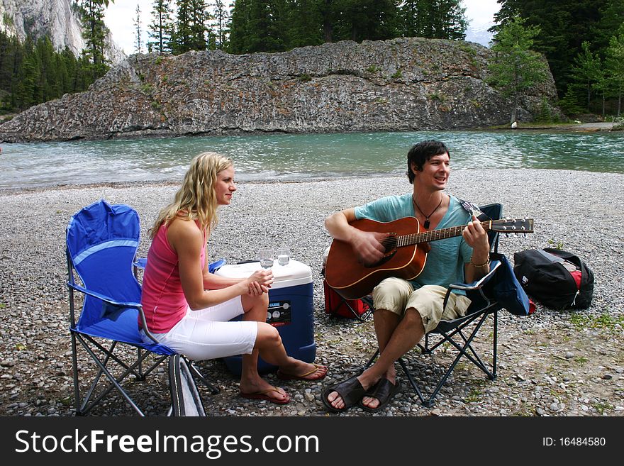 Couple enjoying music on a picnic. Couple enjoying music on a picnic