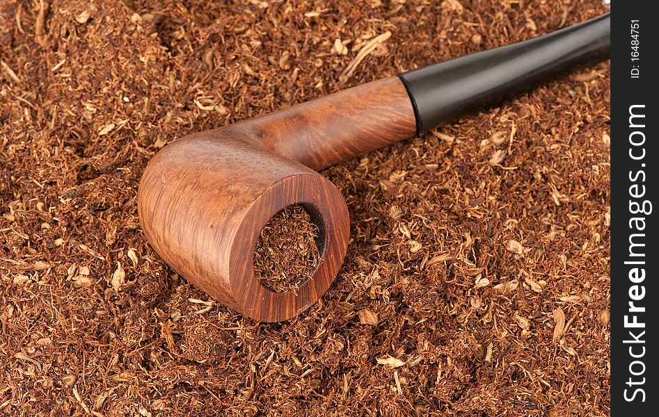 Old pipe with tobacco closeup