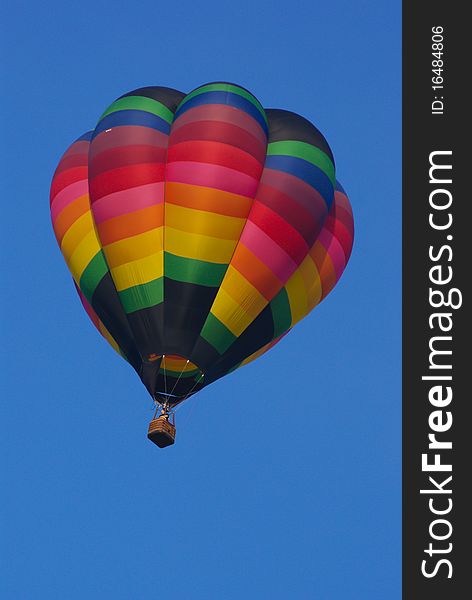 Hot air balloon in flight with clear blue sky background. Hot air balloon in flight with clear blue sky background.
